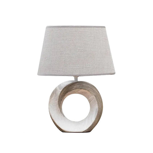 Lampa stołowa z okrągłą podstawą i lnianym abażurem